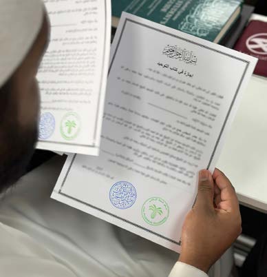 A student holding an ijāzah certificate