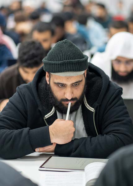 An Alimiyyah student concentrating in class